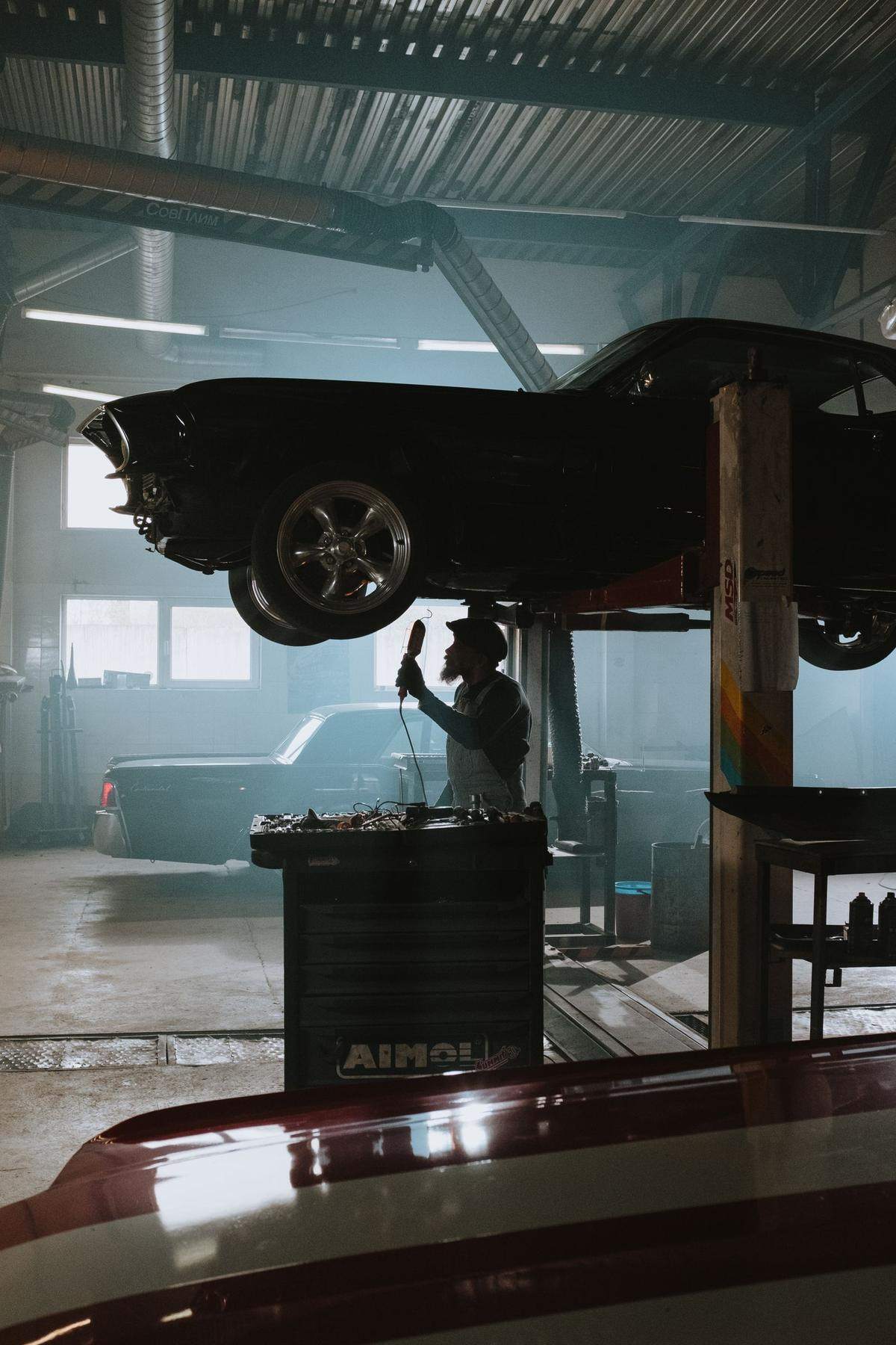 Car raised on a lift in the service bay